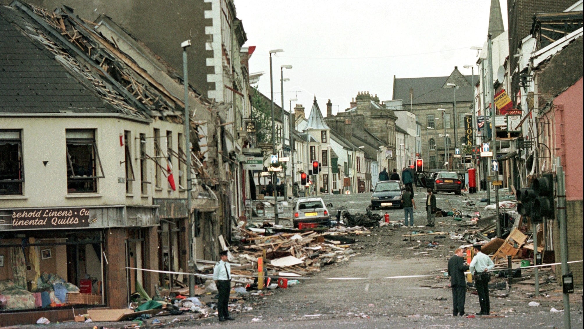 Royal Ulster Constabulary Police officers stand on Market Street, the scene of a car bombing in the centre of Omagh, Co Tyrone, 72 miles west of Belfast, Northern Ireland on Aug. 15, 1998 