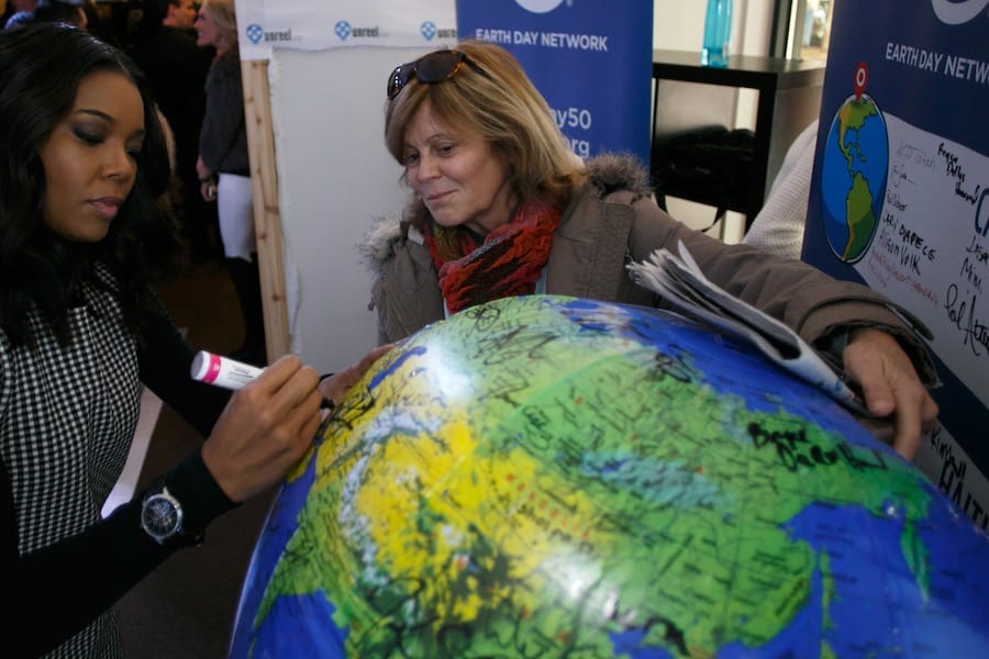 Kathleen Rogers looks at a globe.