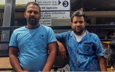 Two men wait outside a passport office in Sri Lanka.