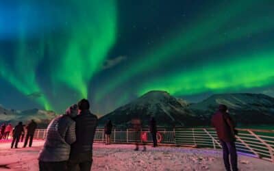 Cruise passengers watch as an aurora covers the sky along the Norwegian coast.