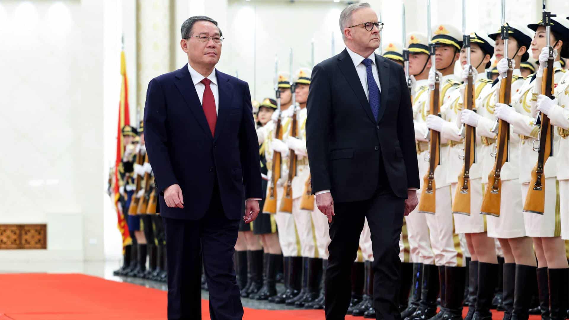 Australian Prime Minister Anthony Albanese, right, walks with Chinese Premier Li Qiang during a ceremonial welcome at the Great Hall of the People in Beijing.