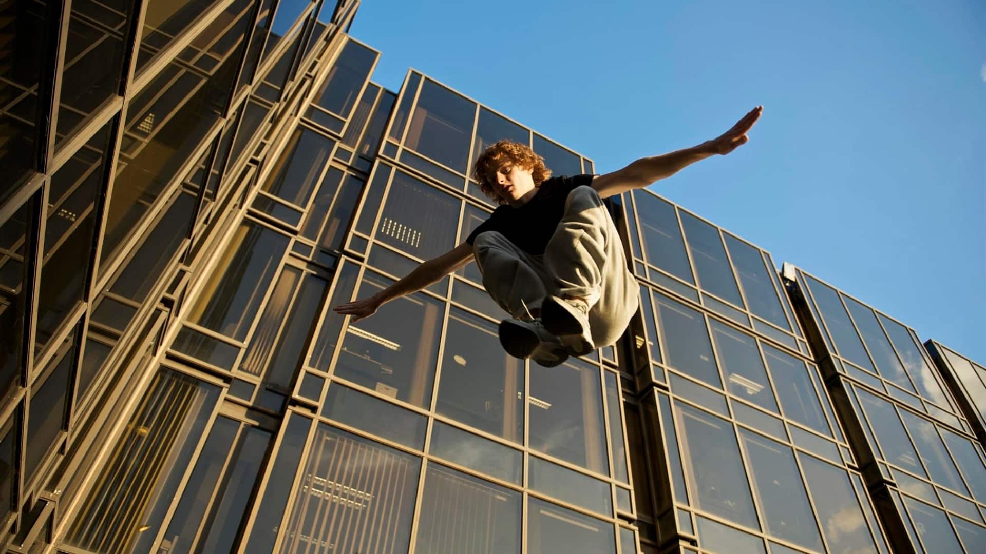 A traceur leaps in the air practicing parkour