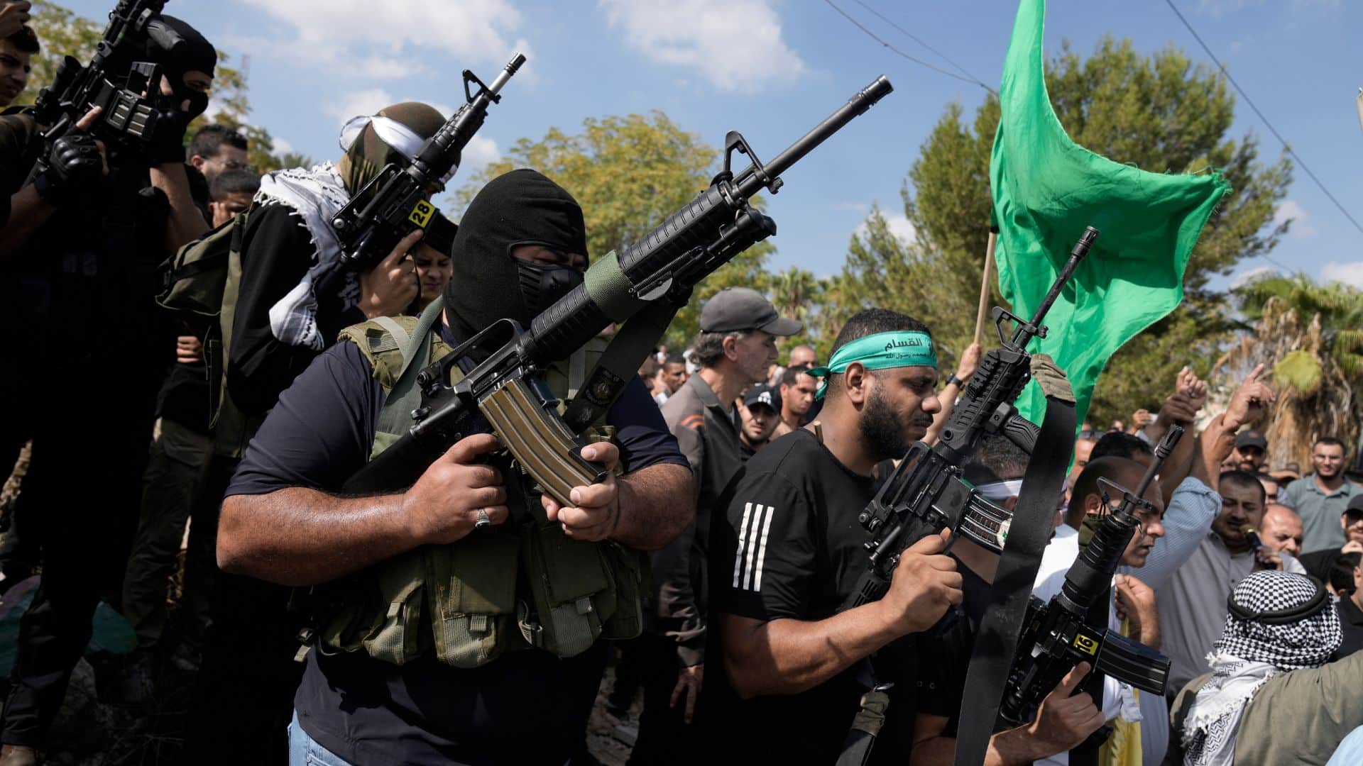 Palestinian militants attend a funeral of people killed during an Israeli military raid on a Palestinian refugee camp, Nur Shams, in the West Bank.