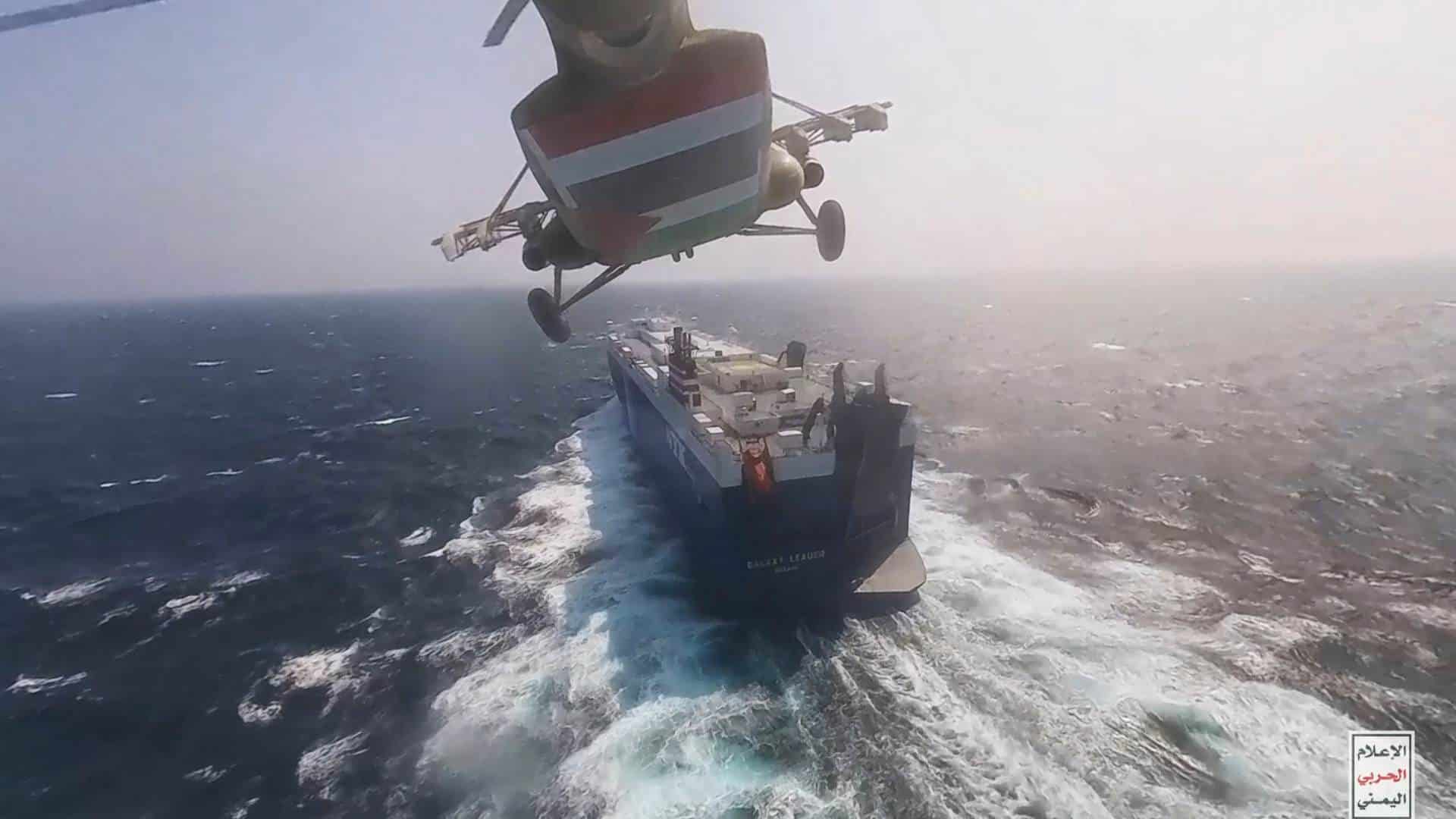A Houthi forces helicopter approaching the cargo ship Galaxy Leader on 19 November 2023. Yemen's Houthis have seized the ship in the Red Sea off the coast of Yemen after threatening to seize all vessels owned by Israeli companies. 