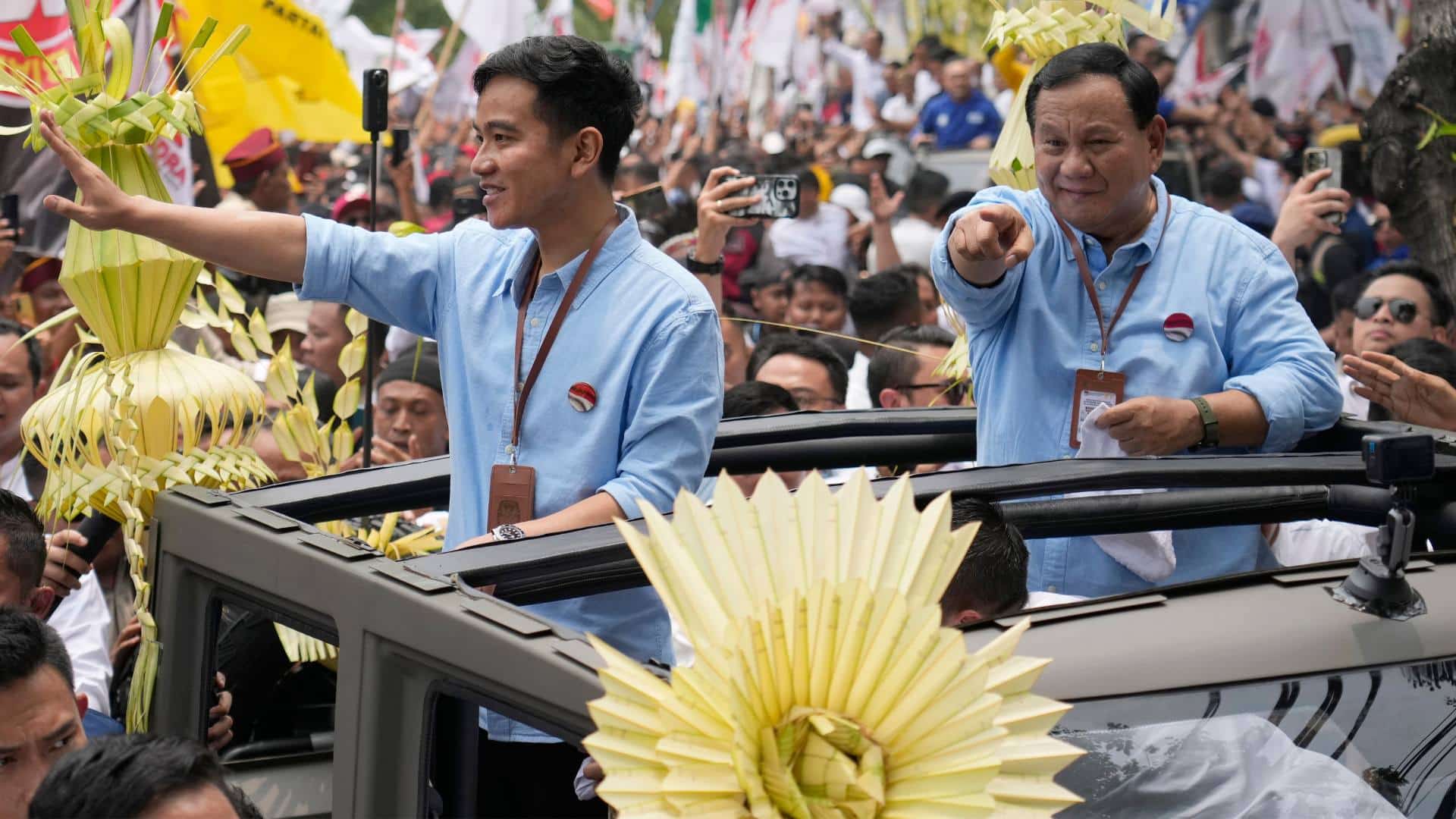 Indonesian presidential candidate Prabowo Subianto, right, and his running mate Gibran Rakabuming Raka, the eldest son of President Joko Widodo, greet supporters upon arrival to register their candidacy to run in the 2024 election, at the General Election Commission building in Jakarta, Indonesia.