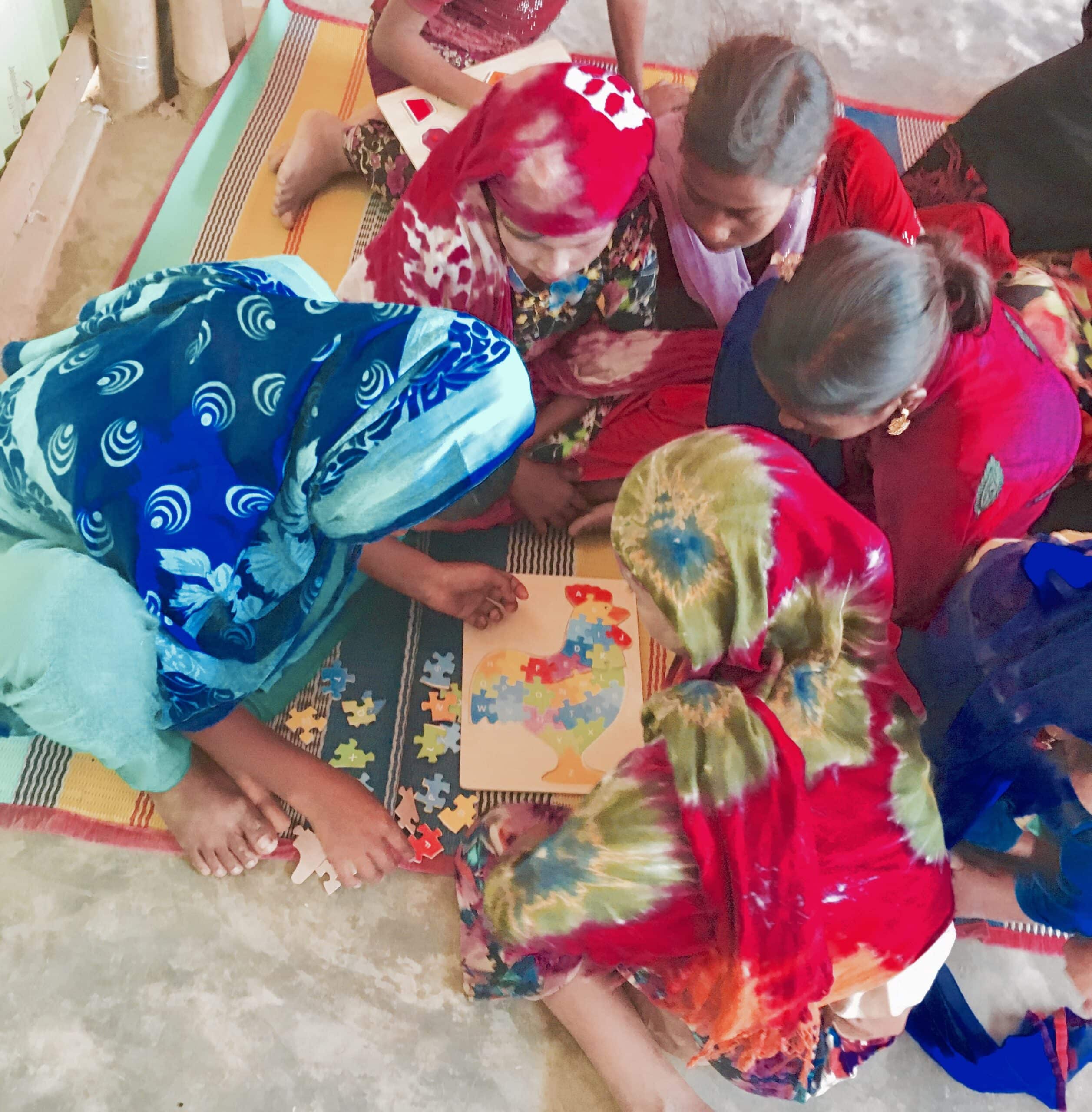 Kids in a classroom making a puzzle in 2017. 