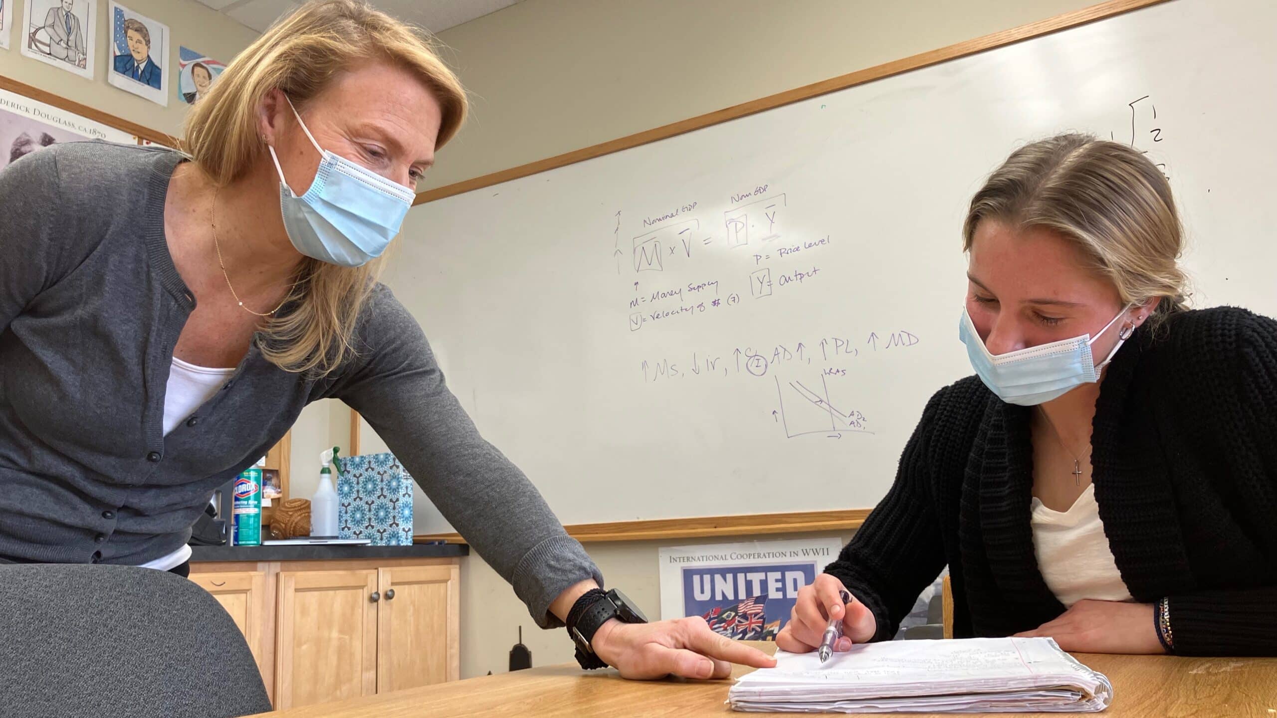 Masked and distanced, Lindsay McConnel helps a high-school student at the Tatnall School.