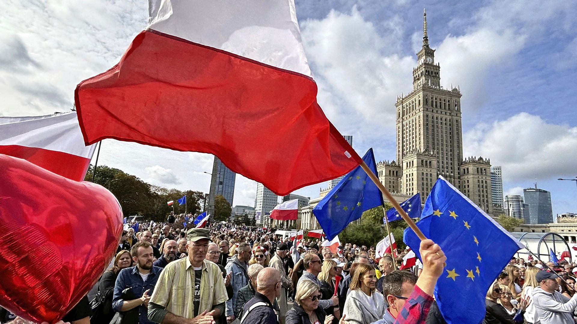 People gather at a rally conducted by opposition party ahead of the general election in Warsaw, Poland