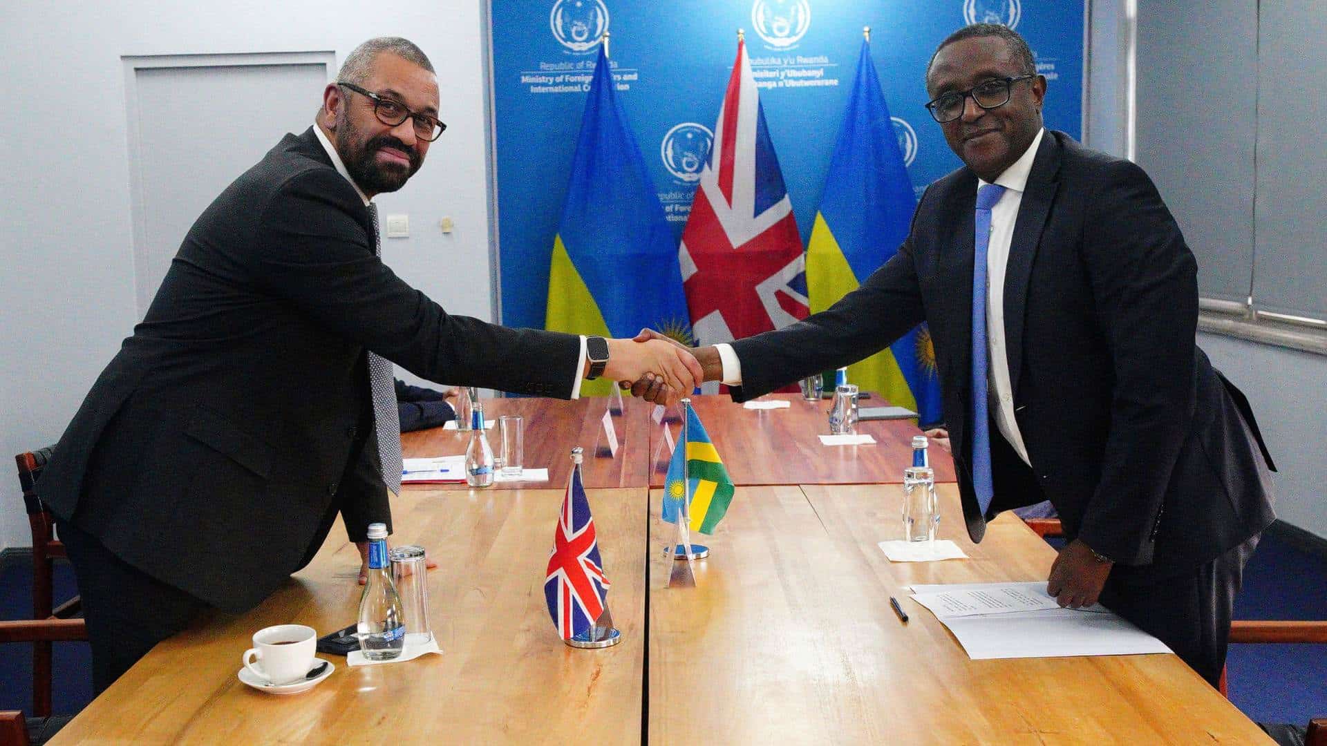 Home Secretary James Cleverly and Rwandan Minister of Foreign Affairs Vincent Biruta shake hands at bilateral meeting after they signed a new treaty in Kigali, Rwanda, Tuesday, Dec. 5, 2023.