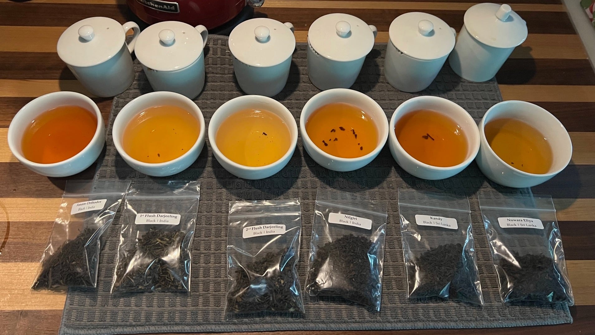 Six black teas from Sri Lanka and India set up for tasting.