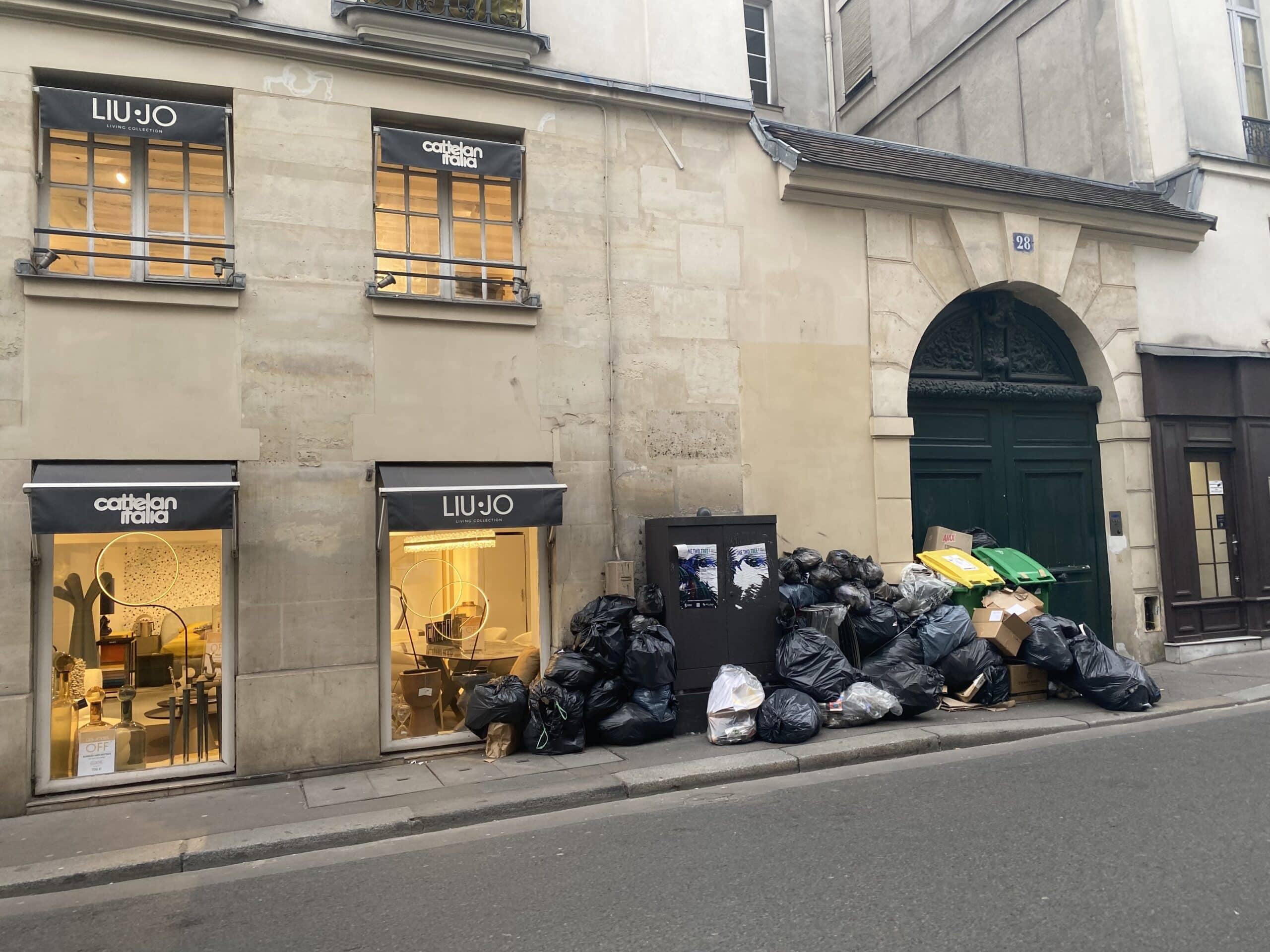 Trash blocks a Parisan sidewalk