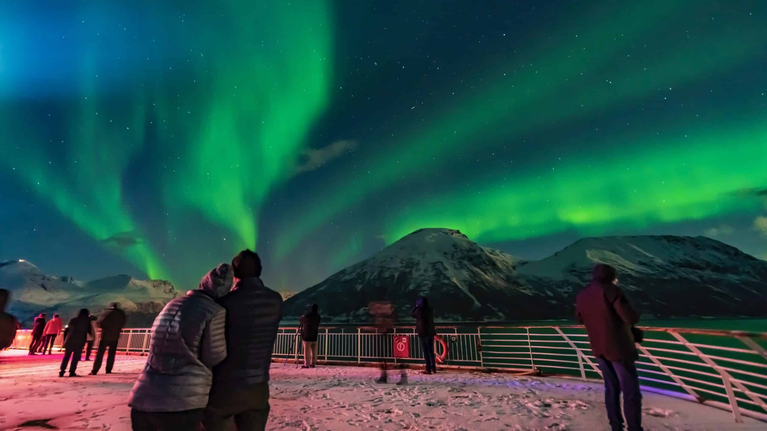Passengers on a cruise observe the Northern Lights in Norway.