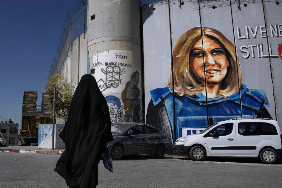 A mural depicting slain Palestinian-American journalist Shireen Abu Akleh is drawn on part of Israel's controversial separation barrier, in the West Bank city of Bethlehem