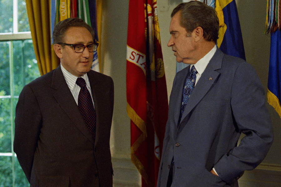Secretary of State Henry Kissinger being congratulated by President Richard Nixon in the Oval office of the White House.